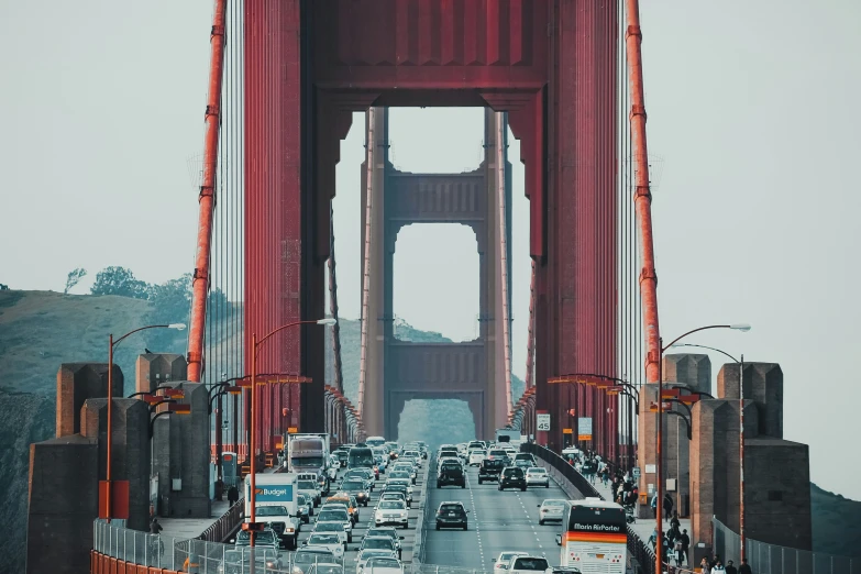 a long line of cars driving across a bridge
