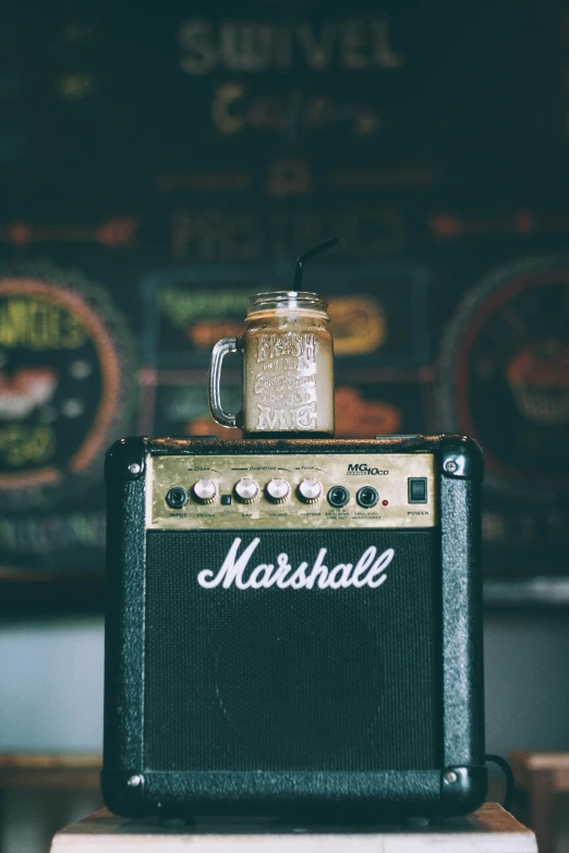 a small mason jar sitting on top of an amp