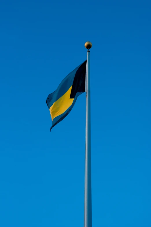 a flag flying high in a clear sky