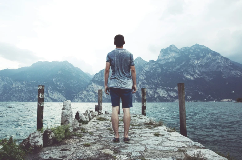 a person on a pier near some water