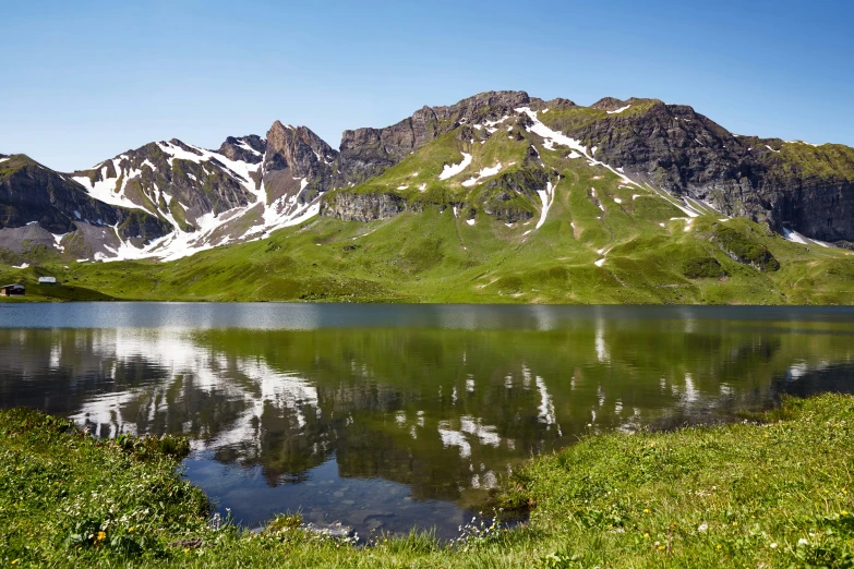 a lake surrounded by snow covered mountains