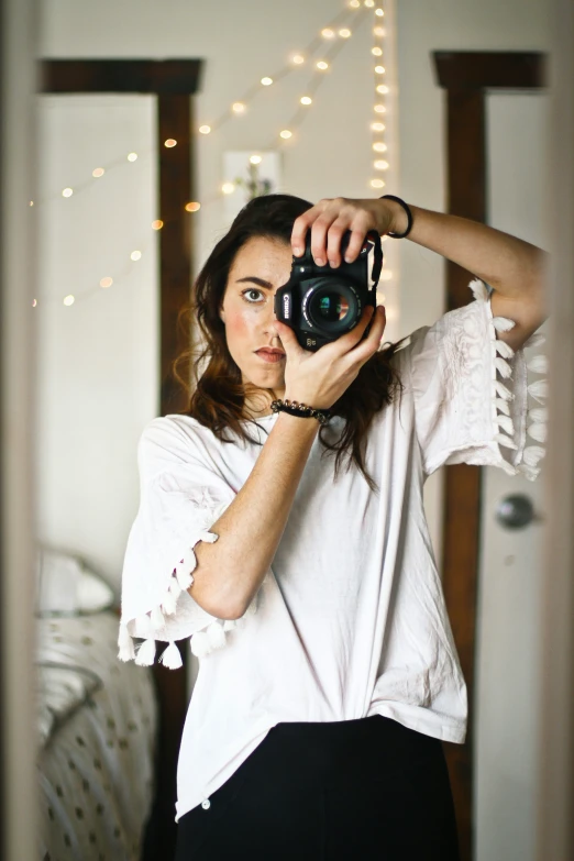 a girl is taking a selfie with a camera