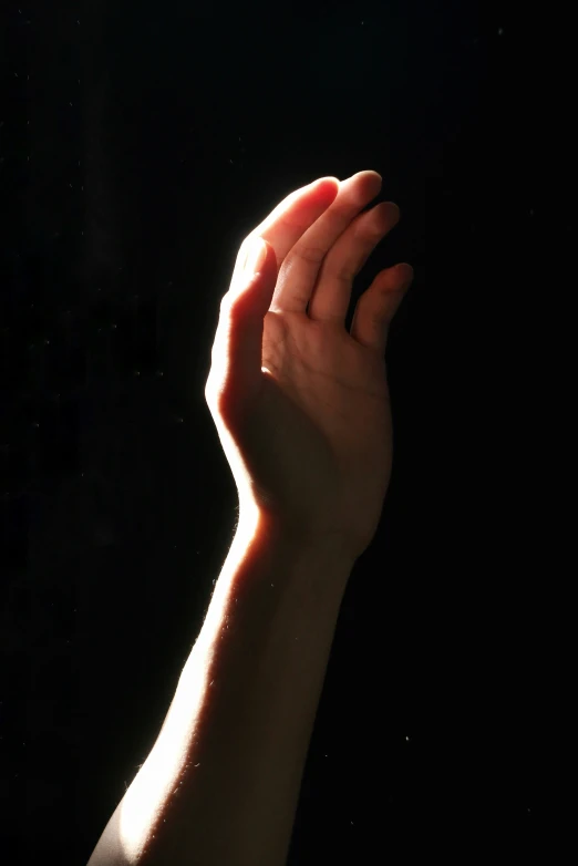 hand and black background with only half lit up