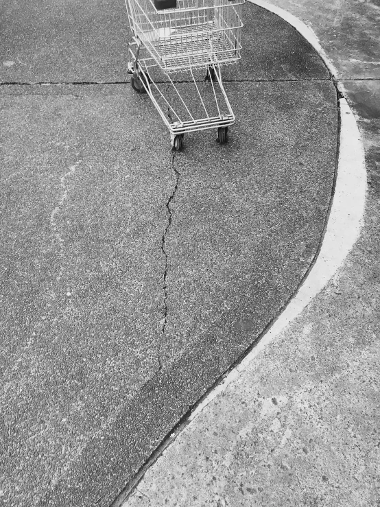 the trolley is empty and the shopping cart is sitting alone