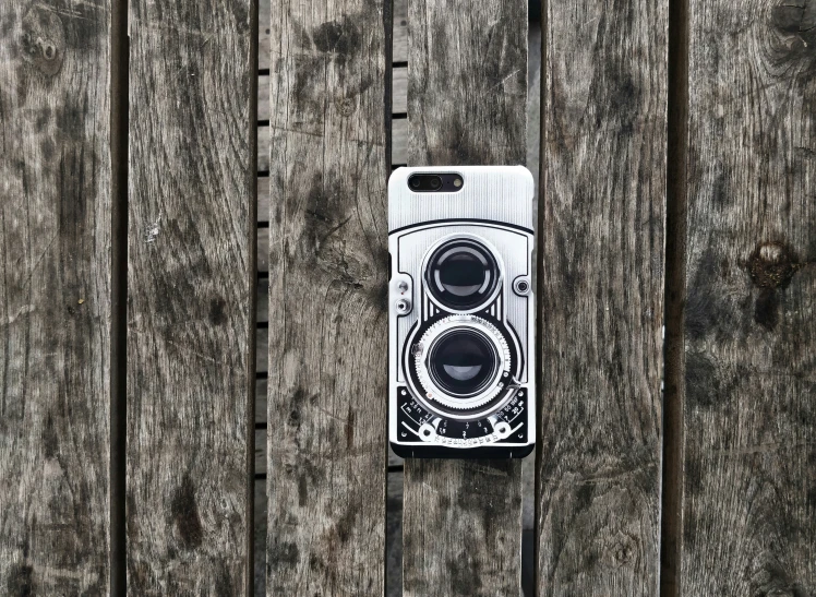 an old cell phone is attached to a wooden wall