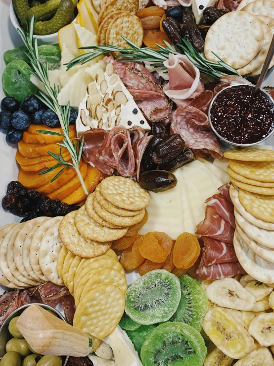 cheese, ers, and other meat and cheese are on this platter