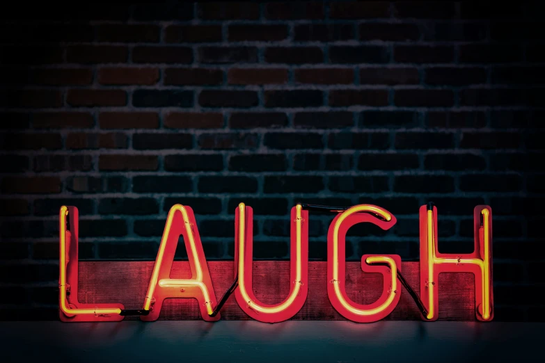 an open sign that reads laugh in large neon letters