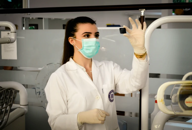 a woman wearing a face mask and gloves