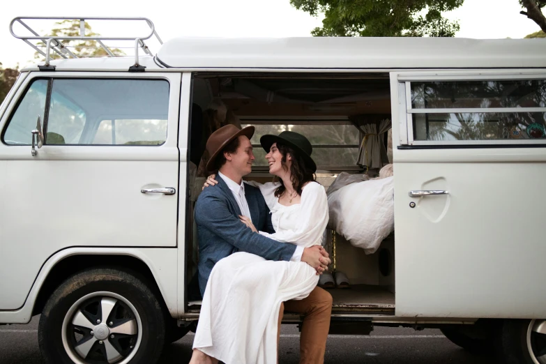 there is a man and a woman sitting in a van