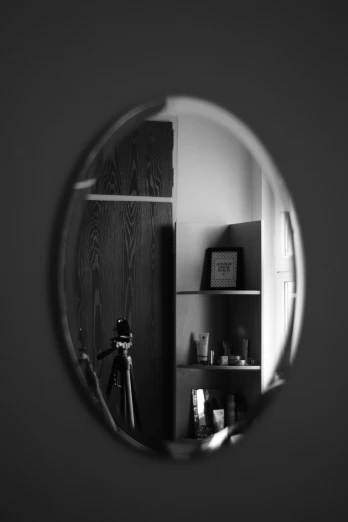 a mirror reflection of a kitchen and shelf