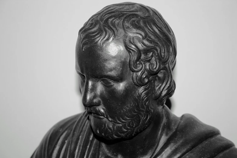 a statue of a man with a beard and hair style