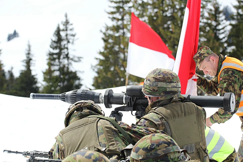 a couple of soldiers with rifles taking pictures of some people