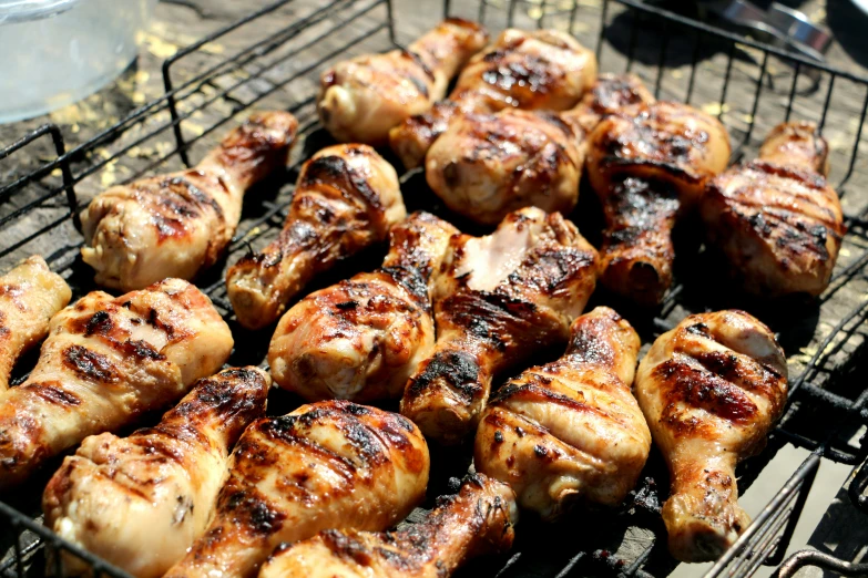 several meat skewers lined up on a grill