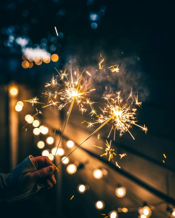 someone holds on to the sparklers that they are holding