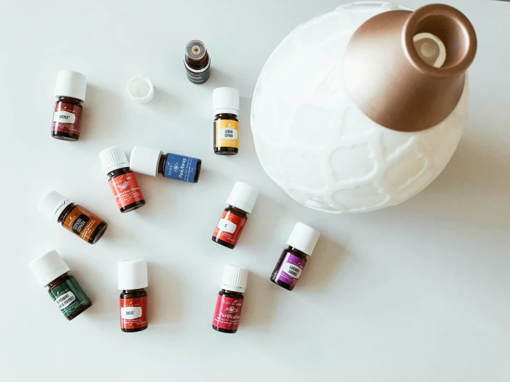 some small bottles of essential oils on a white surface