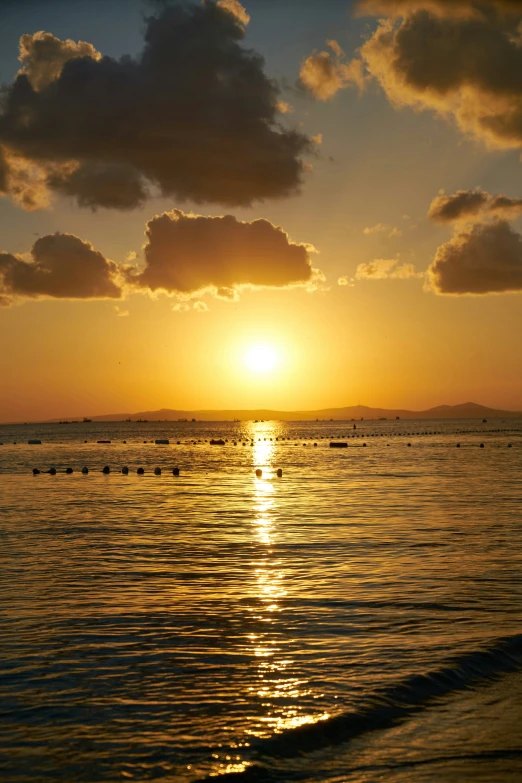 the sun shines brightly in the sky as it is reflected on the water