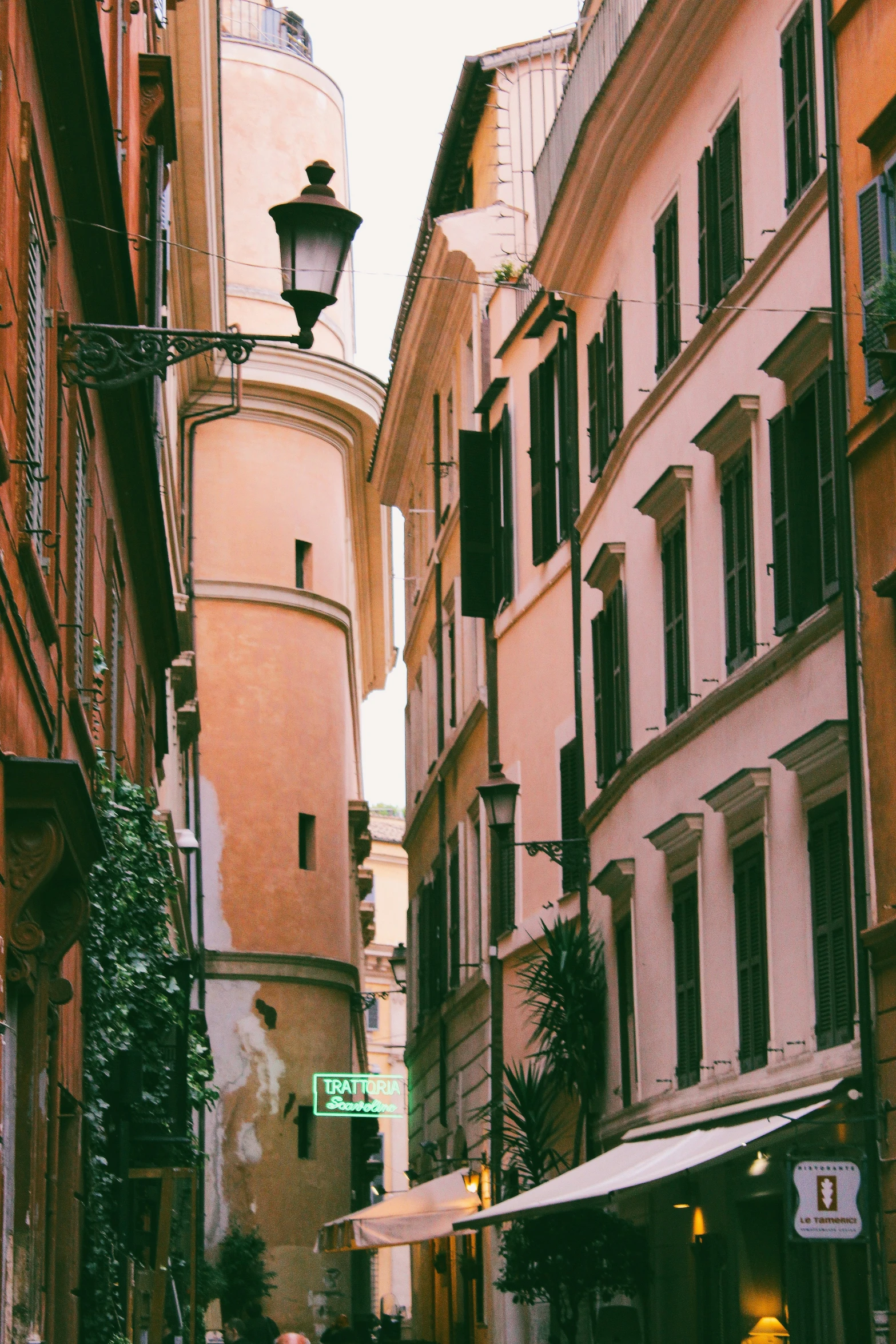 a tall tower sits on the top of a city street