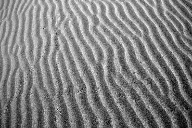 ripples of water, sand, and other objects in a pattern
