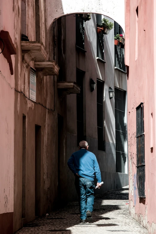 a man is walking down an alley way