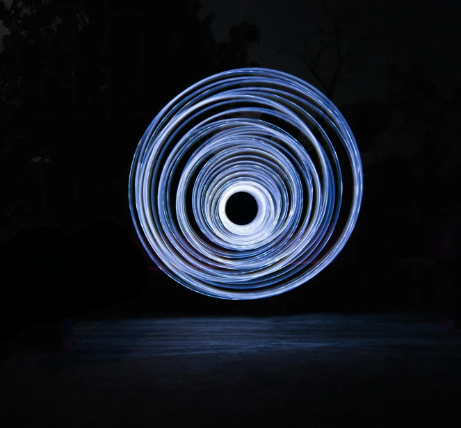 a white circle light painting with a black background