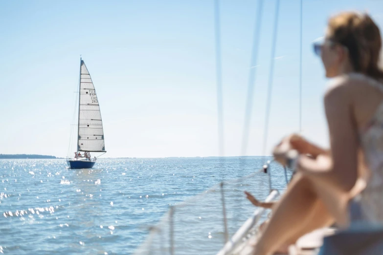 a sailboat sailing on top of water and another boat