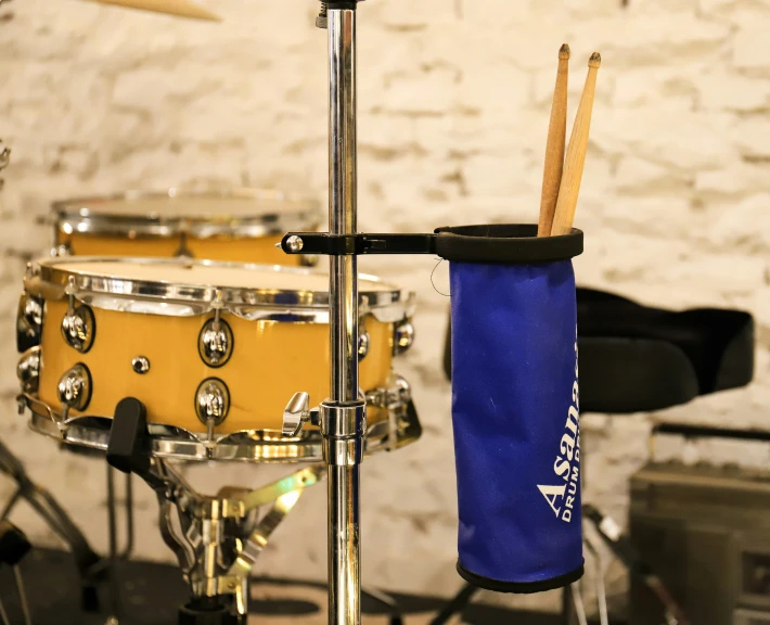 drumsticks are hung up near a drum