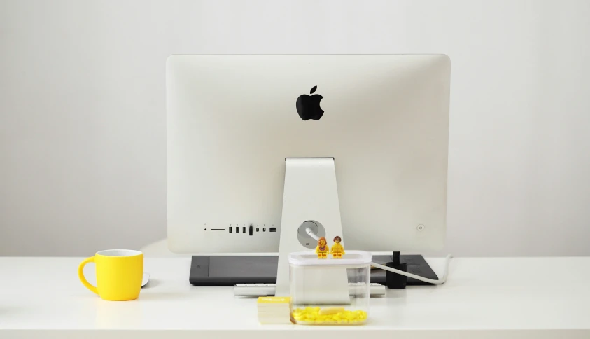 an apple desktop computer on top of a white desk