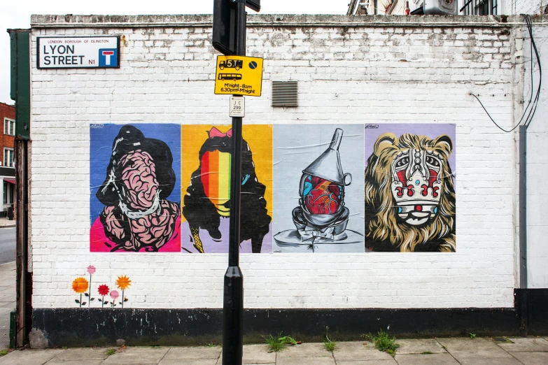 a street light stands in front of an advertit on the side of a building