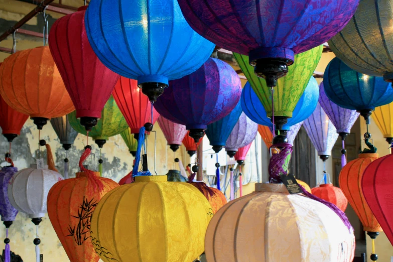 a variety of colorful chinese lanterns are hanging