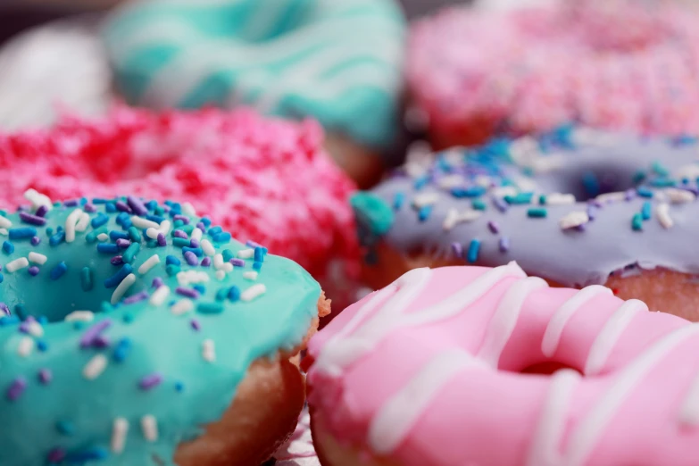 donuts with colorful frosting and sprinkles on the edges