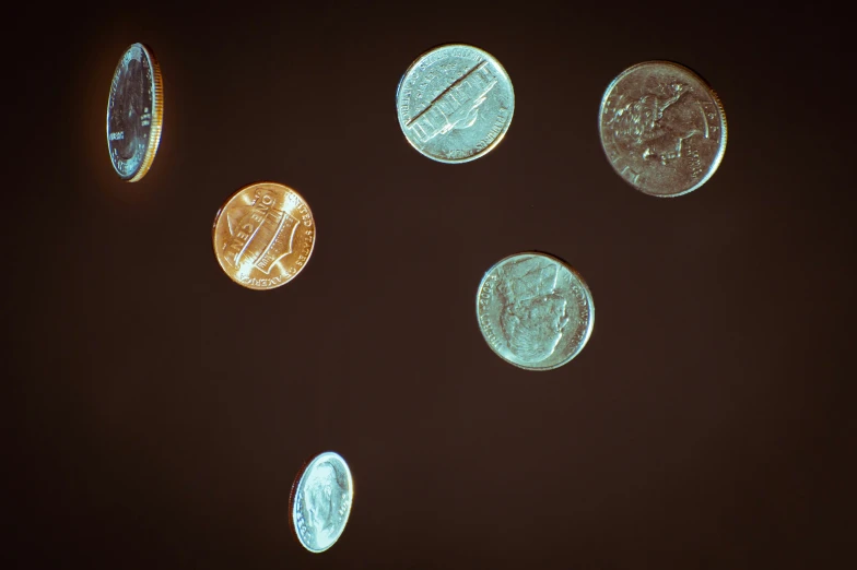 a group of four different colored coin coins