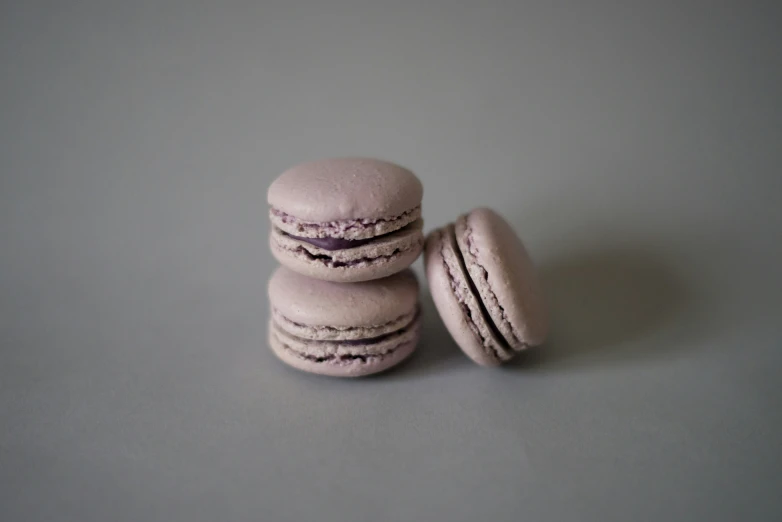 three pink macaroons one has been bitten