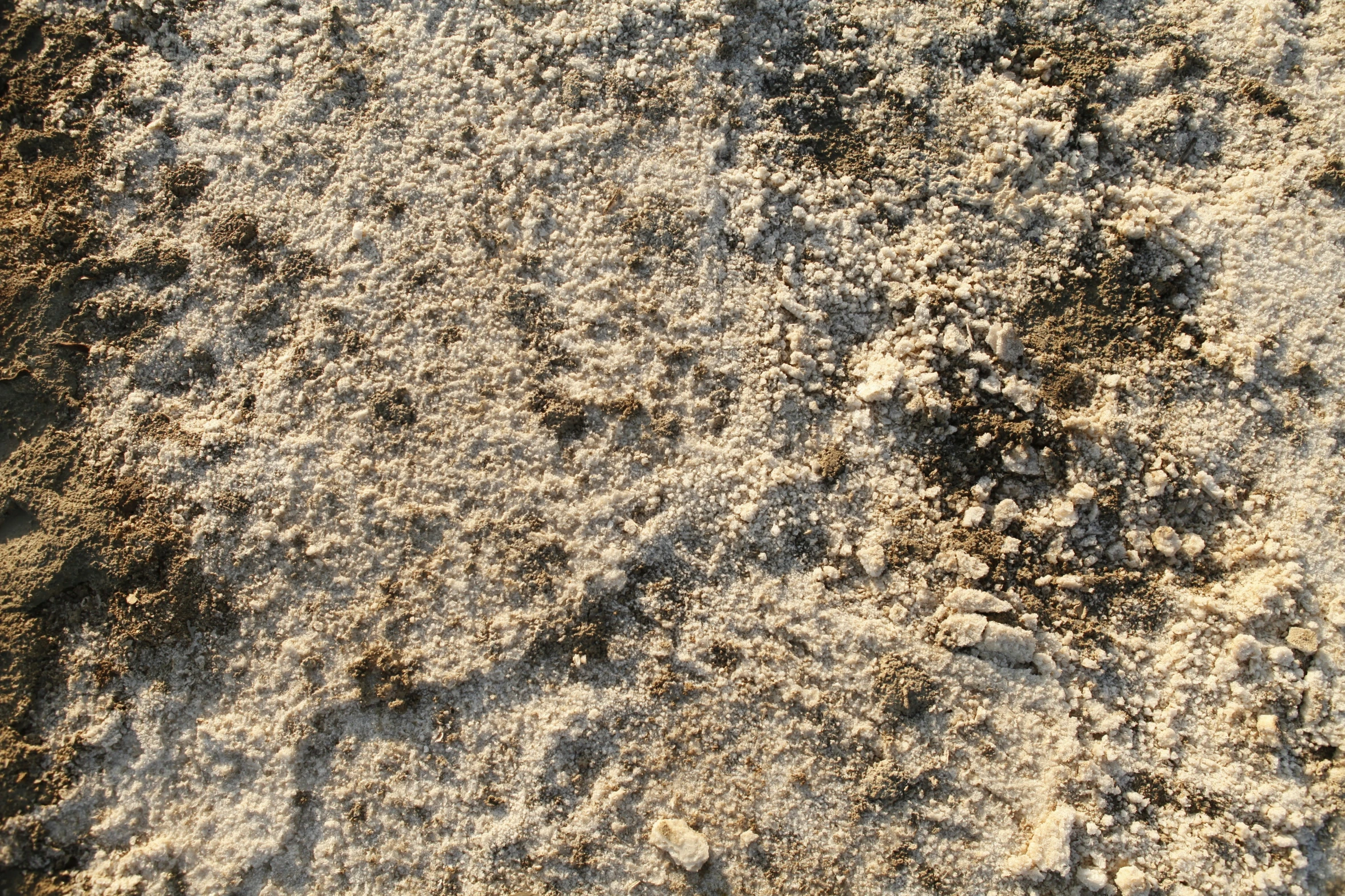 sand with rocks under it that look like a pattern