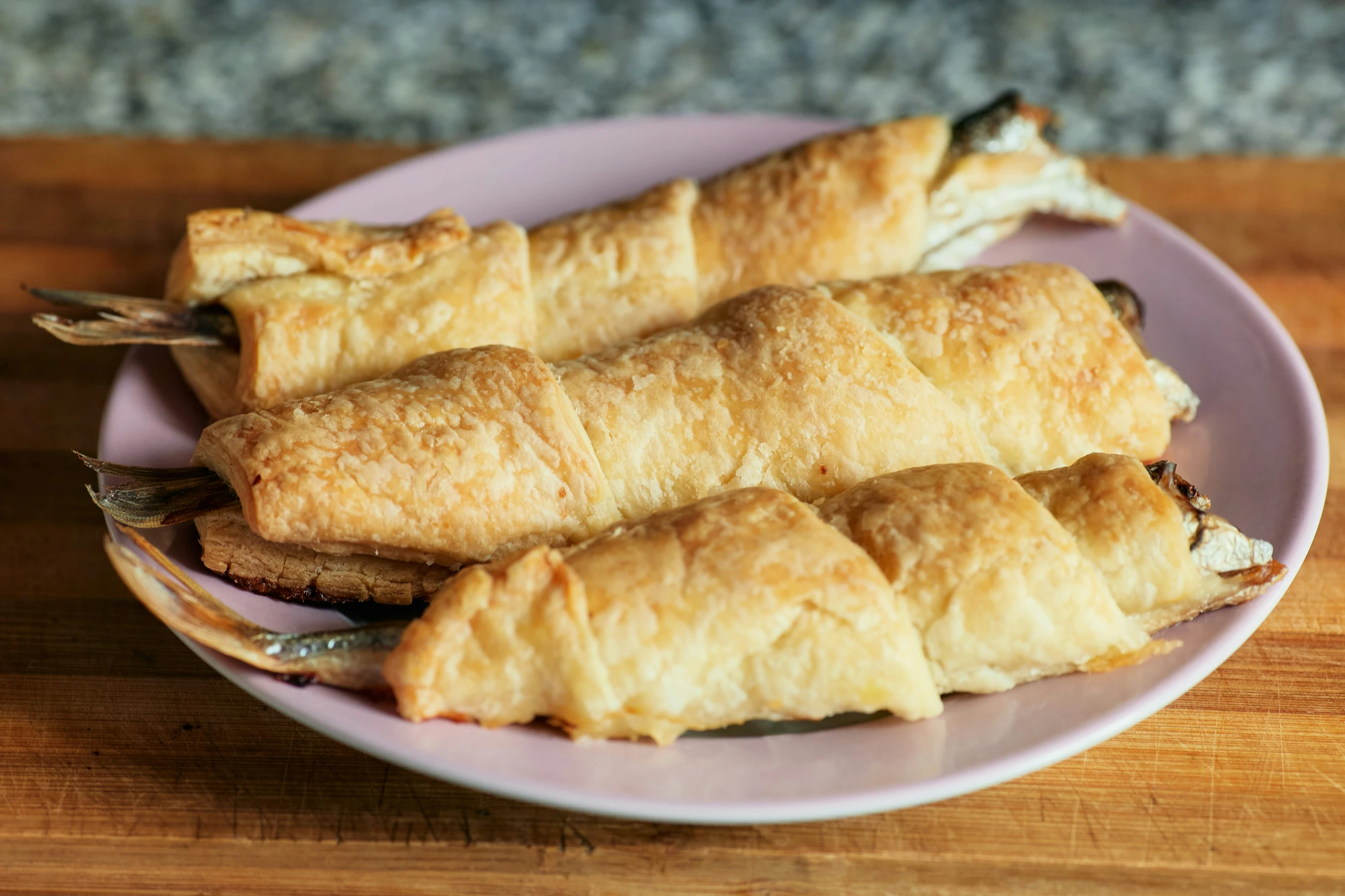 a pink plate topped with three tasty looking food