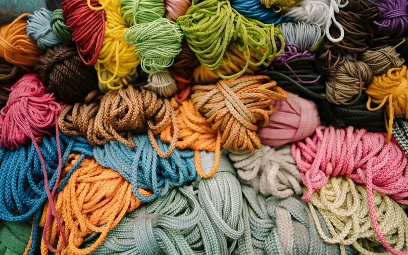 several balls of colorful yarn for sale at an outdoor market