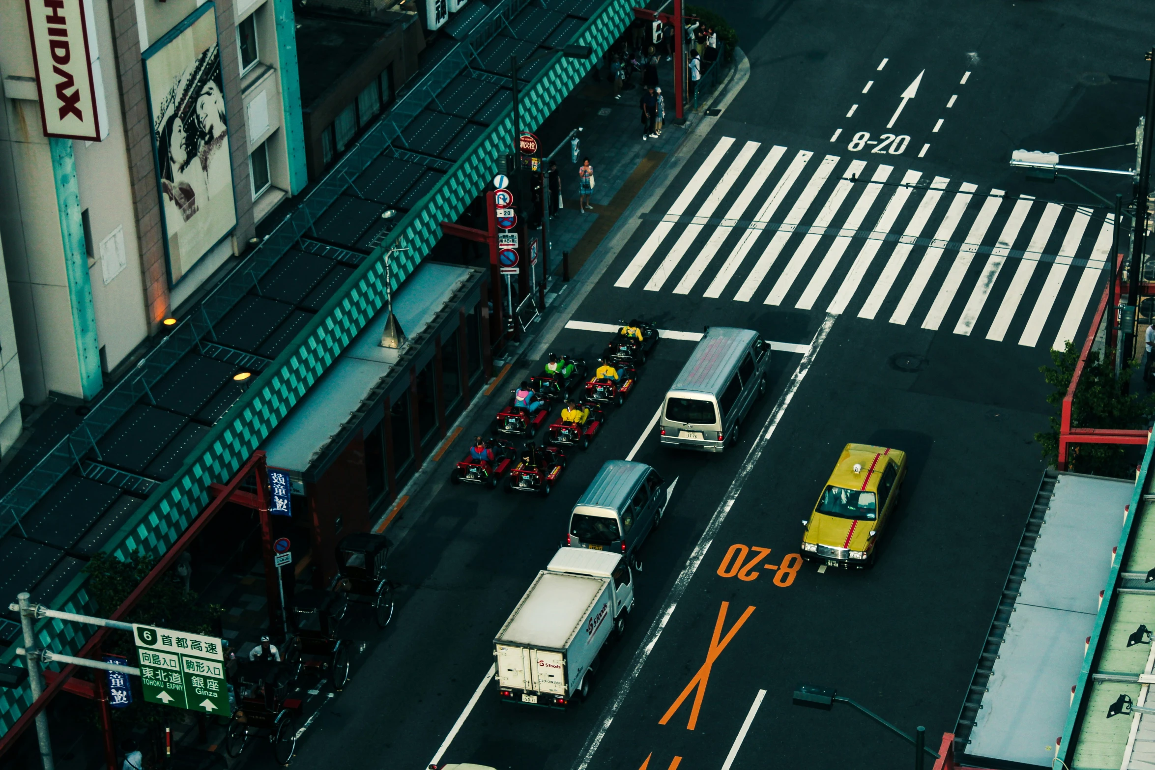 a yellow and white truck is driving through an intersection