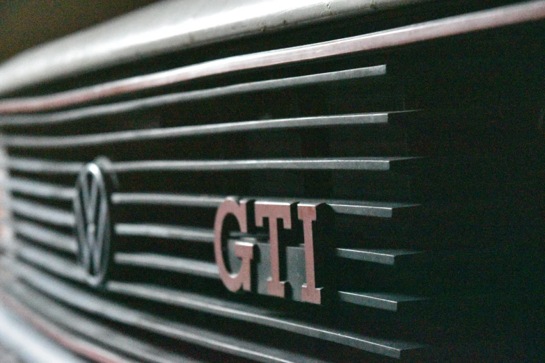 a close up of the letters gtp on a black grill