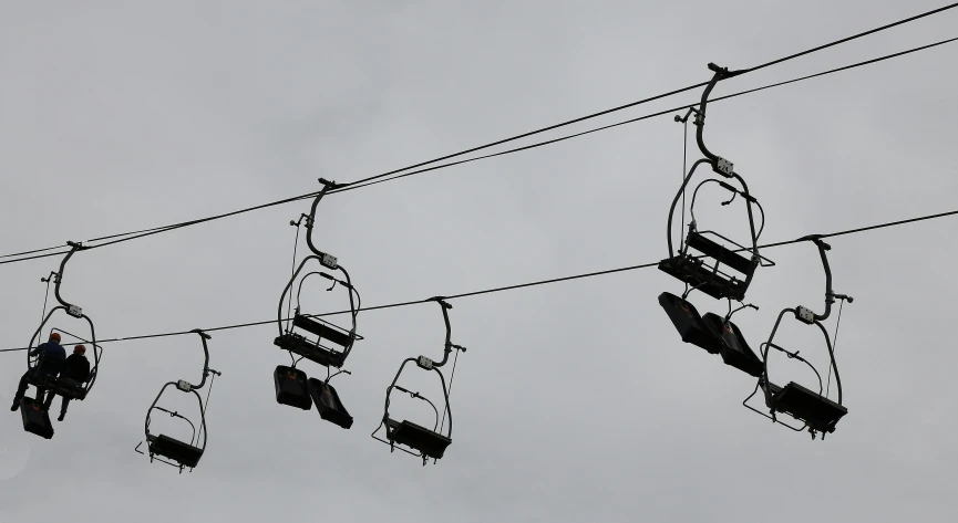 the power lines with various electrical cords on each and various hanging items for display