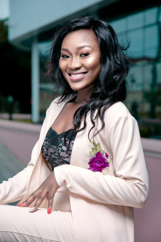 a woman posing for a picture in a white jacket