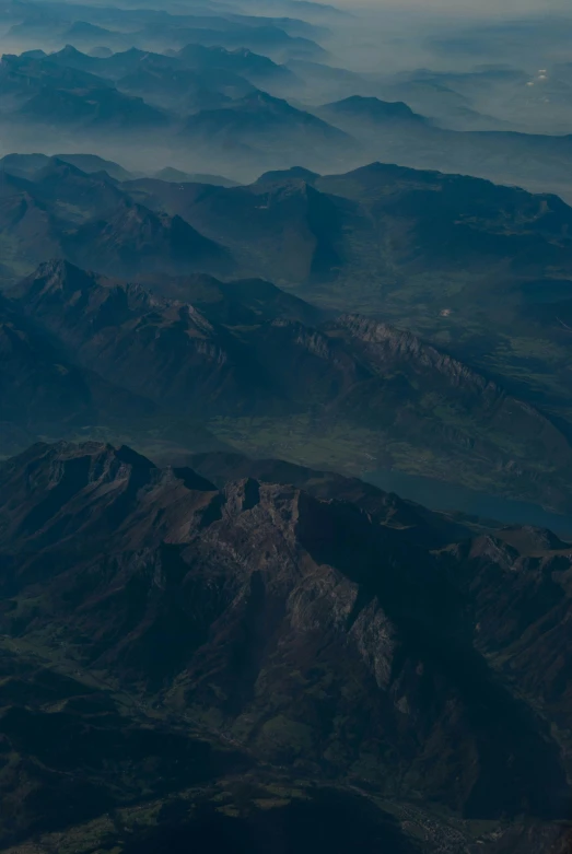 an aerial view of some mountains with hills in the background