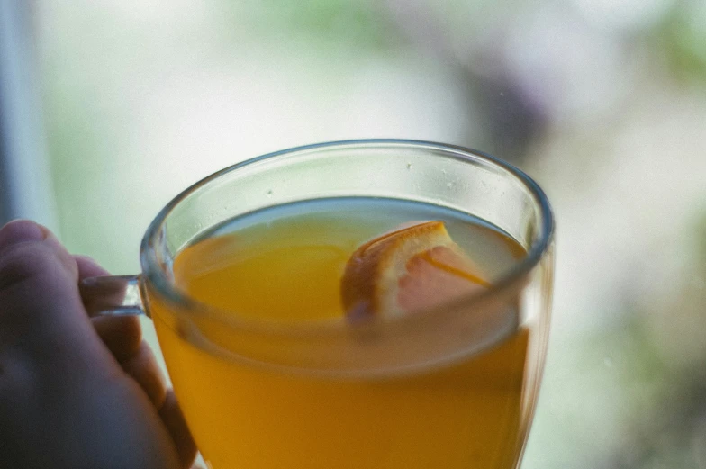 a cup with a liquid in it has an orange peel