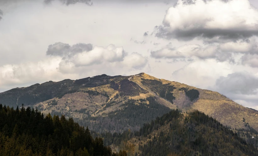 the mountains are covered in snow and clouds