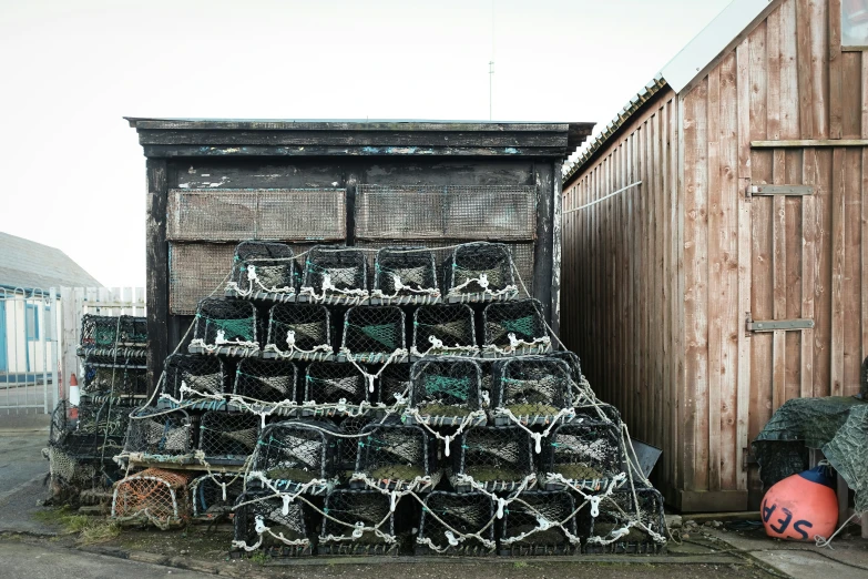 several wire baskets stacked on each other in front of a building