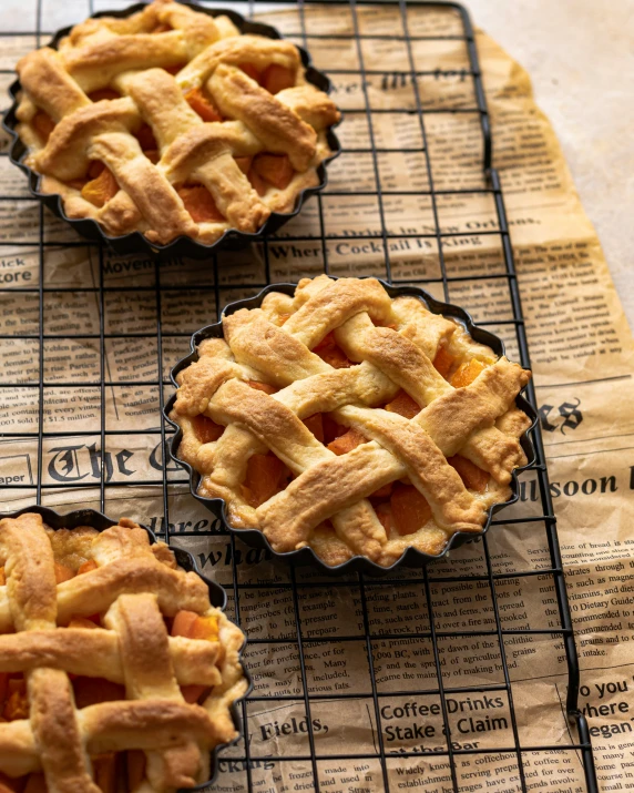 three pies cooling on top of a wire rack