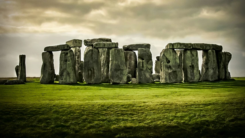 an image of a stonehenge setting in the grass