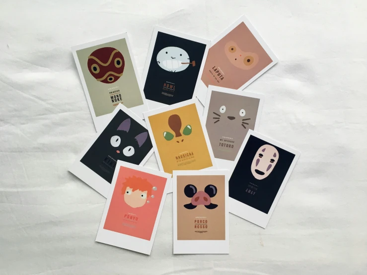 seven cards with different shapes of cats and faces