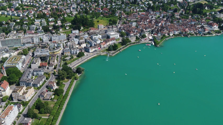 a lake near a city with lots of buildings