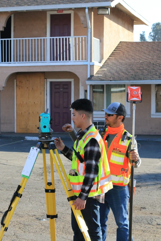 two men using an ipad to take pictures