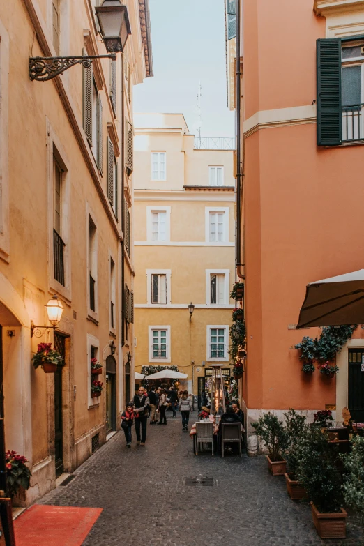 people are walking on a narrow alley way