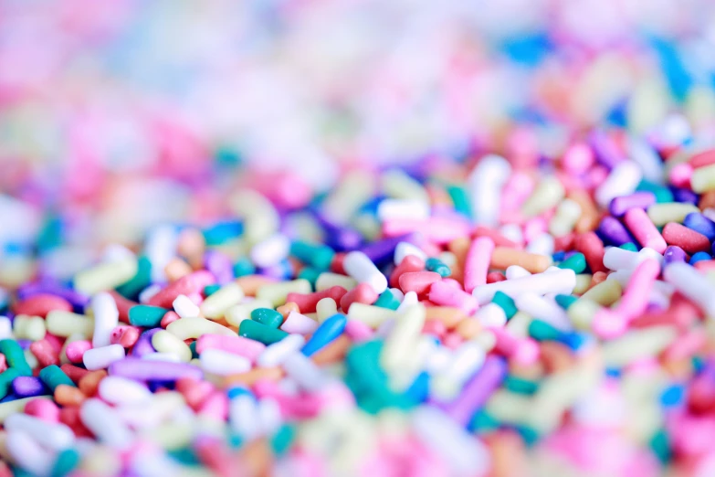 sprinkles and colorful cereal mixed up on a white surface